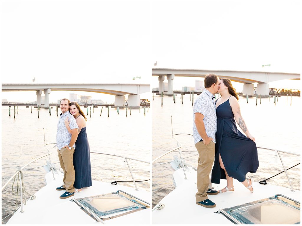 Couple posing and kissing on the edge of a boat in Jacksonville, FL. 