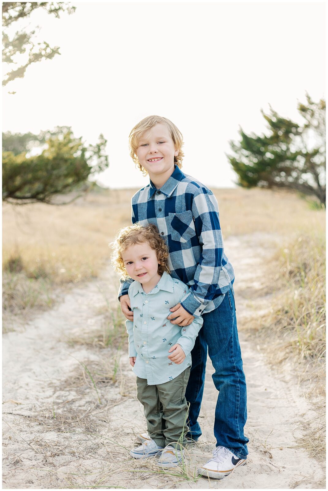 Brothers standing together on a sandy path