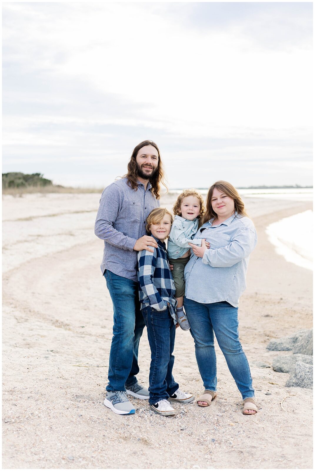 Coastal Family Photos in Northeast Florida Parents and children standing together in soft winter light