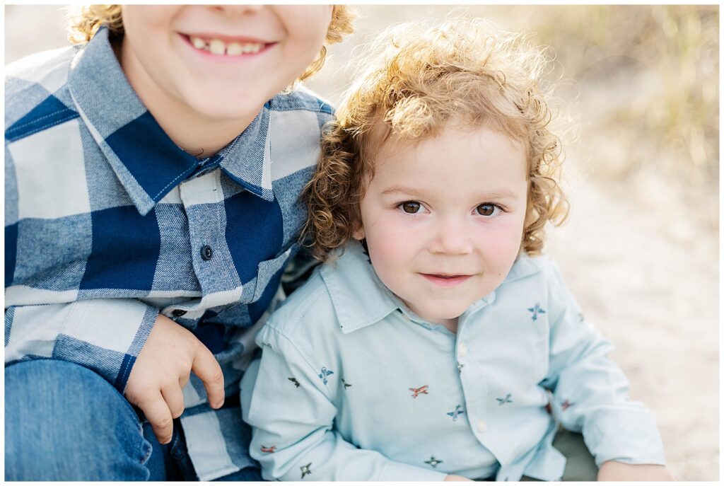 Young boy smiling during a coastal family session near Fernandina Beach