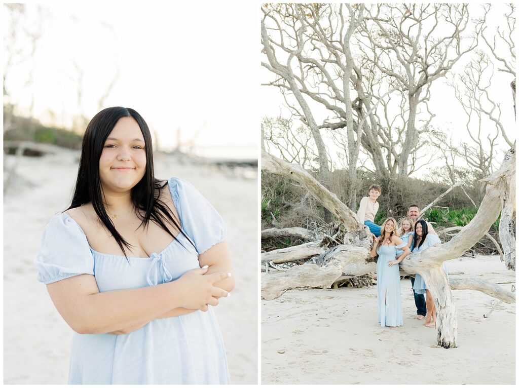 A coastal family portrait featuring a young woman in a light blue dress and her family gathered around sculptural driftwood on a quiet beach