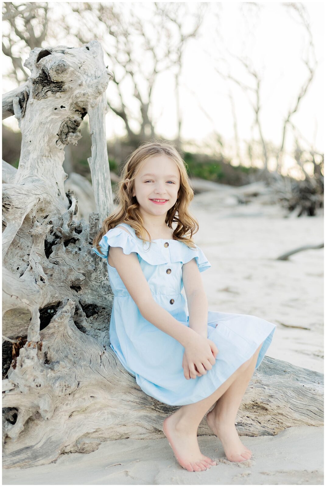 A child smiling confidently during a natural portrait outdoors