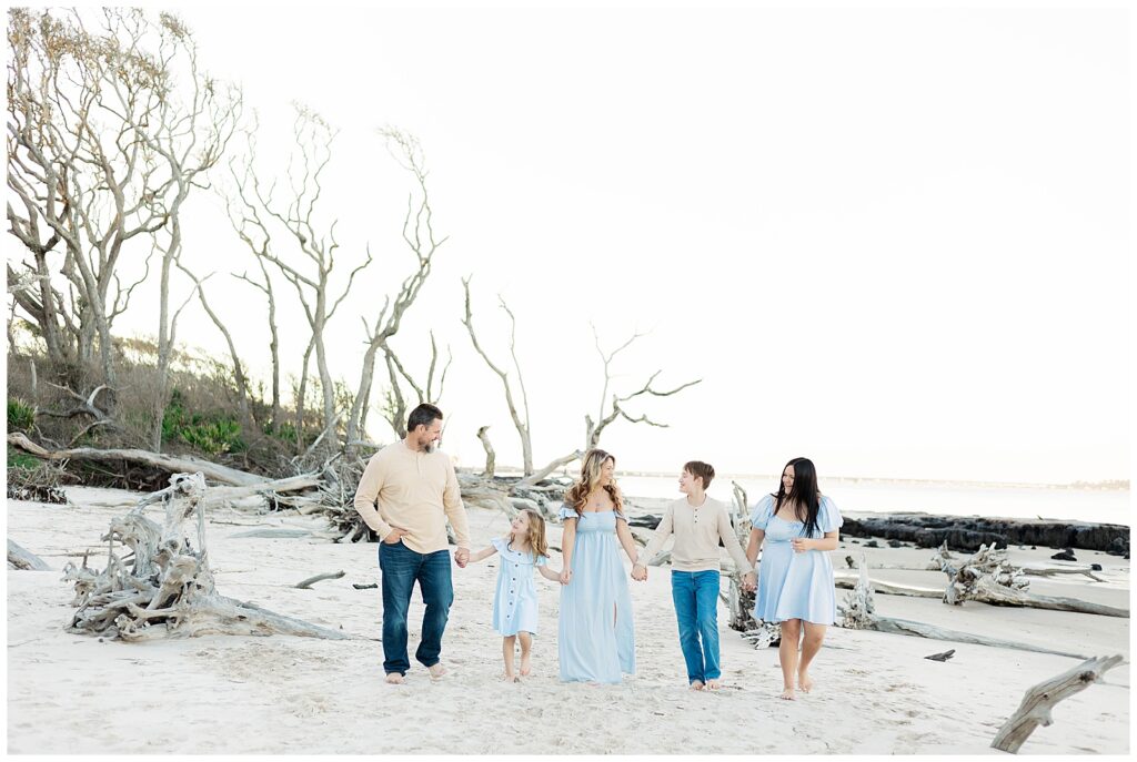 Coastal family portrait with natural connection, soft light, and organic driftwood textures