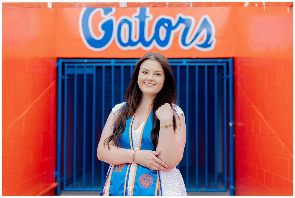 University of Florida graduate smiling during a UF grad session at Ben Hill Griffin Stadium