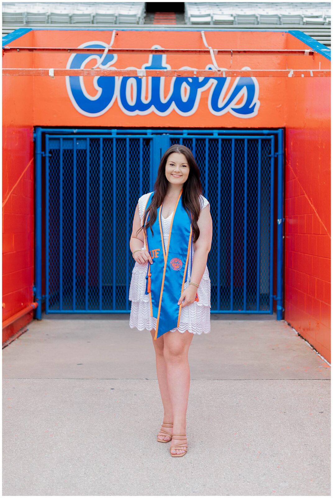 UF grad session at Ben Hill Griffin Stadium featuring a University of Florida graduate in blue and orange stole