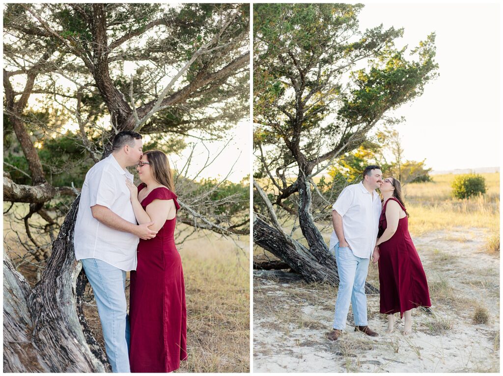Couple standing close together beneath windswept trees at Fort Clinch State Park during an engagement session in Fernandina Beach